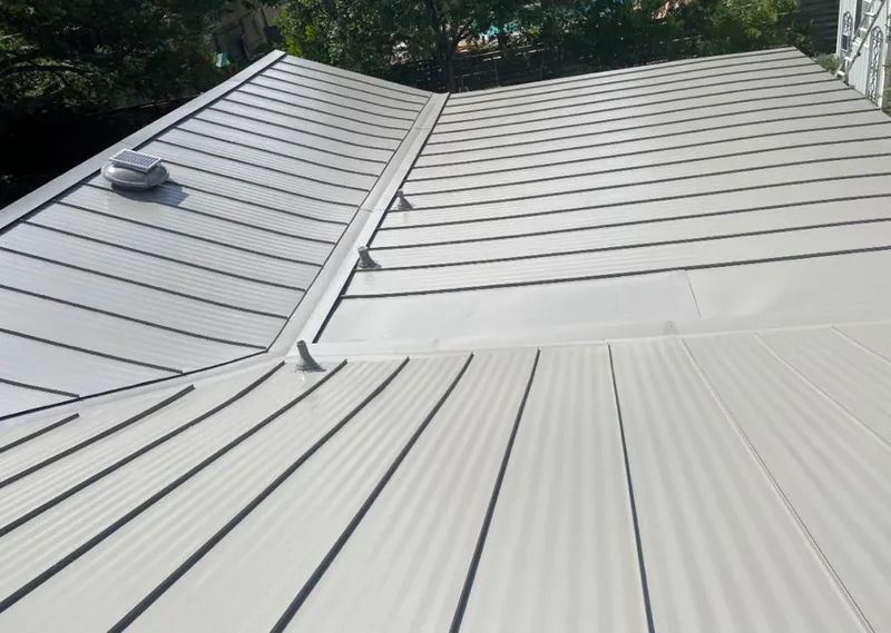 Solar attic fan installed on a metal roof for Roof Ventilation in Rushville